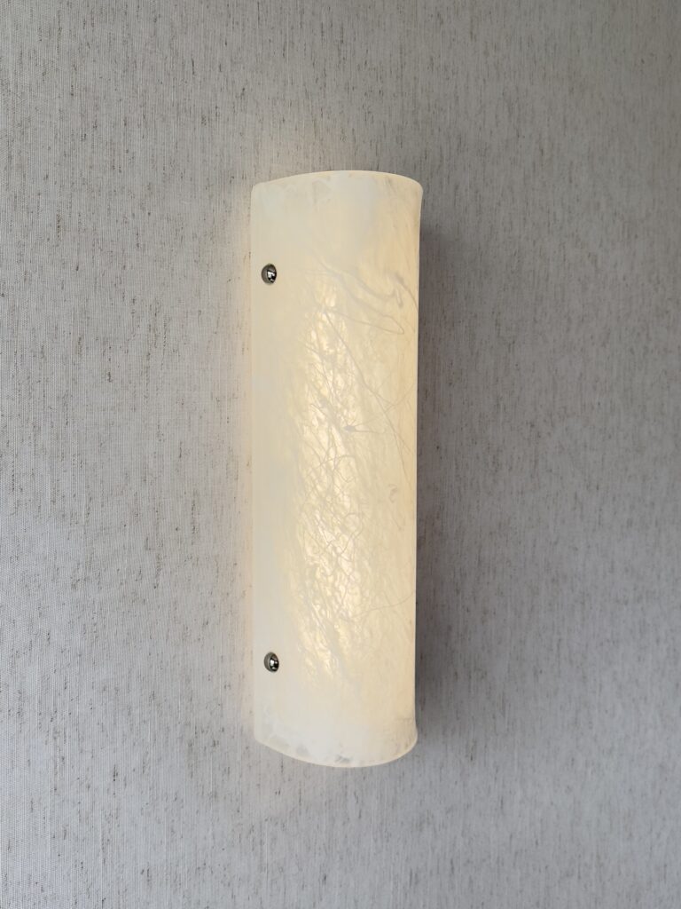 Wireless resin wall sconce with white quartz-inspired finish