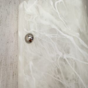 Wireless resin wall sconce with white quartz-inspired finish