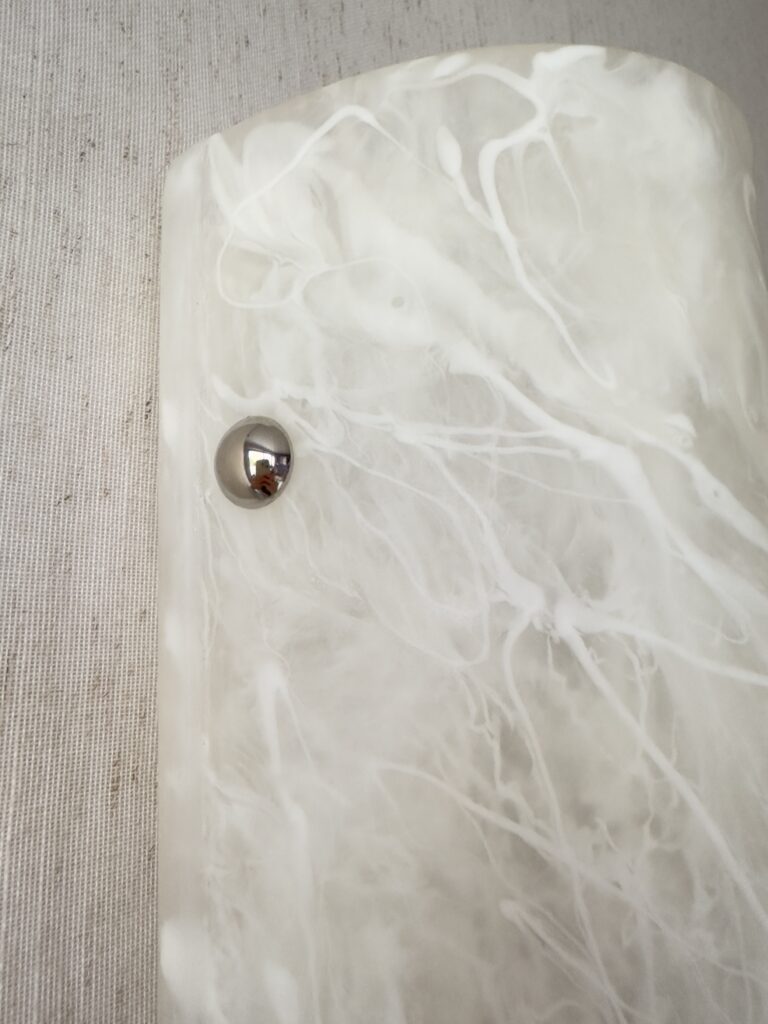 Wireless resin wall sconce with white quartz-inspired finish