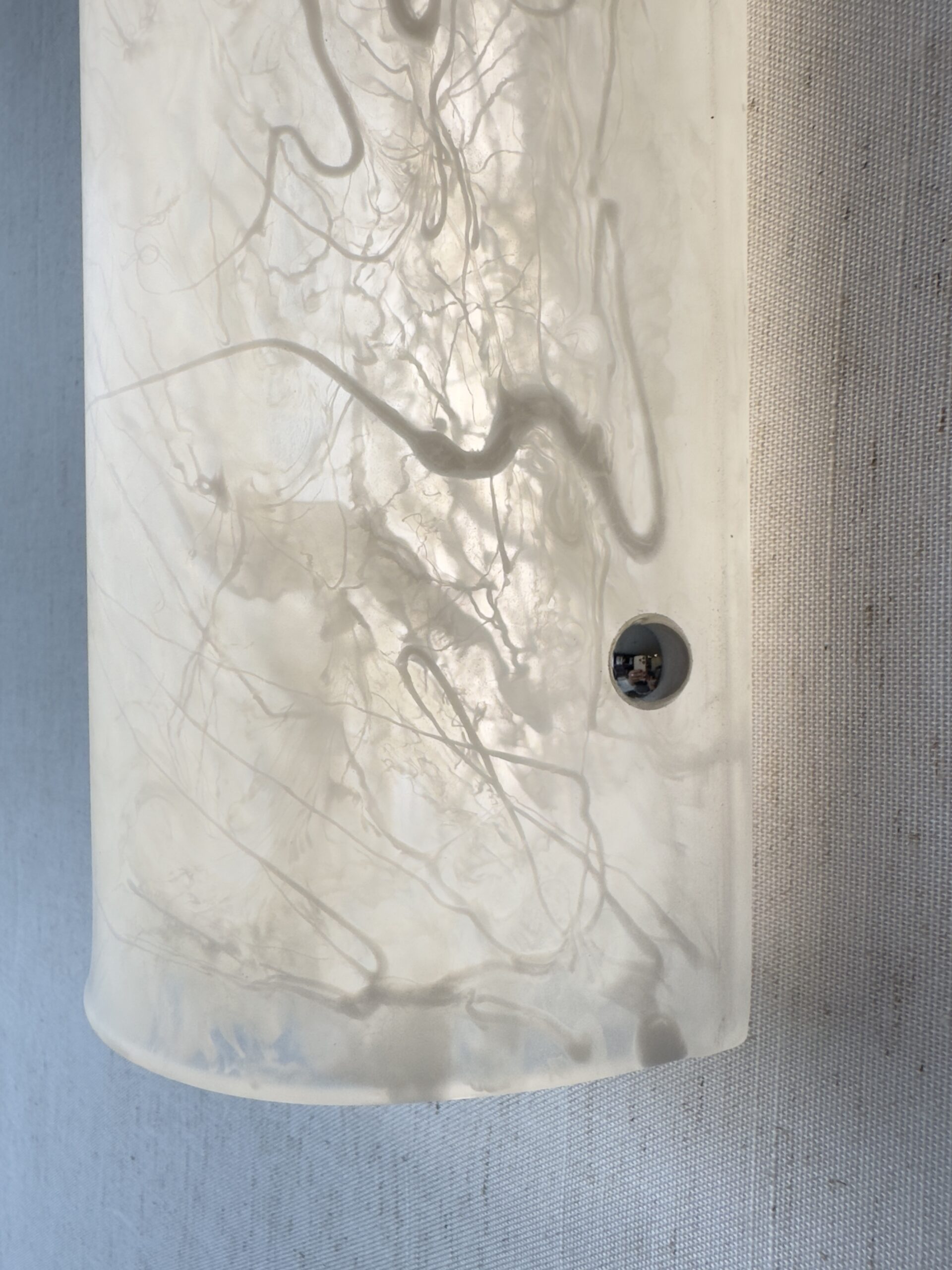 Wireless resin wall sconce with white quartz-inspired finish