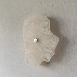 Wireless resin wall sconce with white quartz-inspired finish