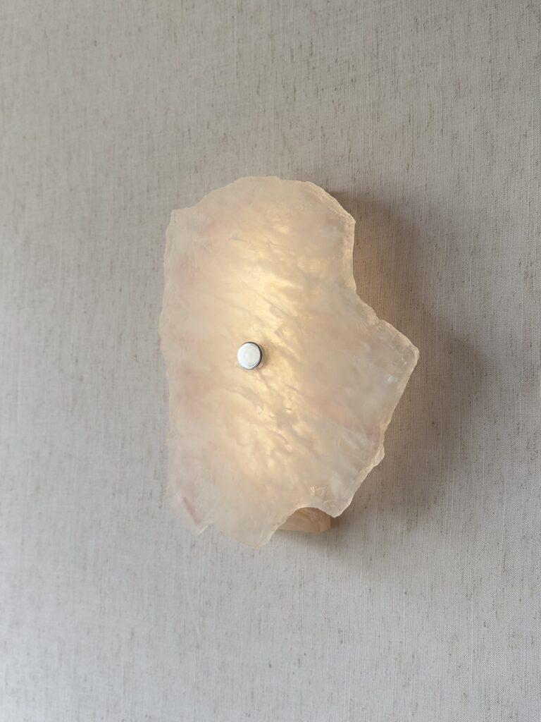 Wireless resin wall sconce with white quartz-inspired finish