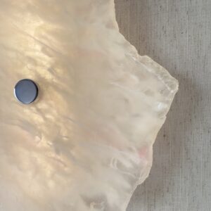Wireless resin wall sconce with white quartz-inspired finish