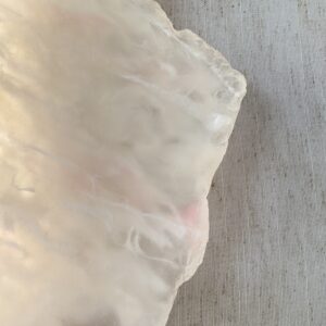 Wireless resin wall sconce with white quartz-inspired finish