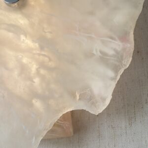 Wireless resin wall sconce with white quartz-inspired finish