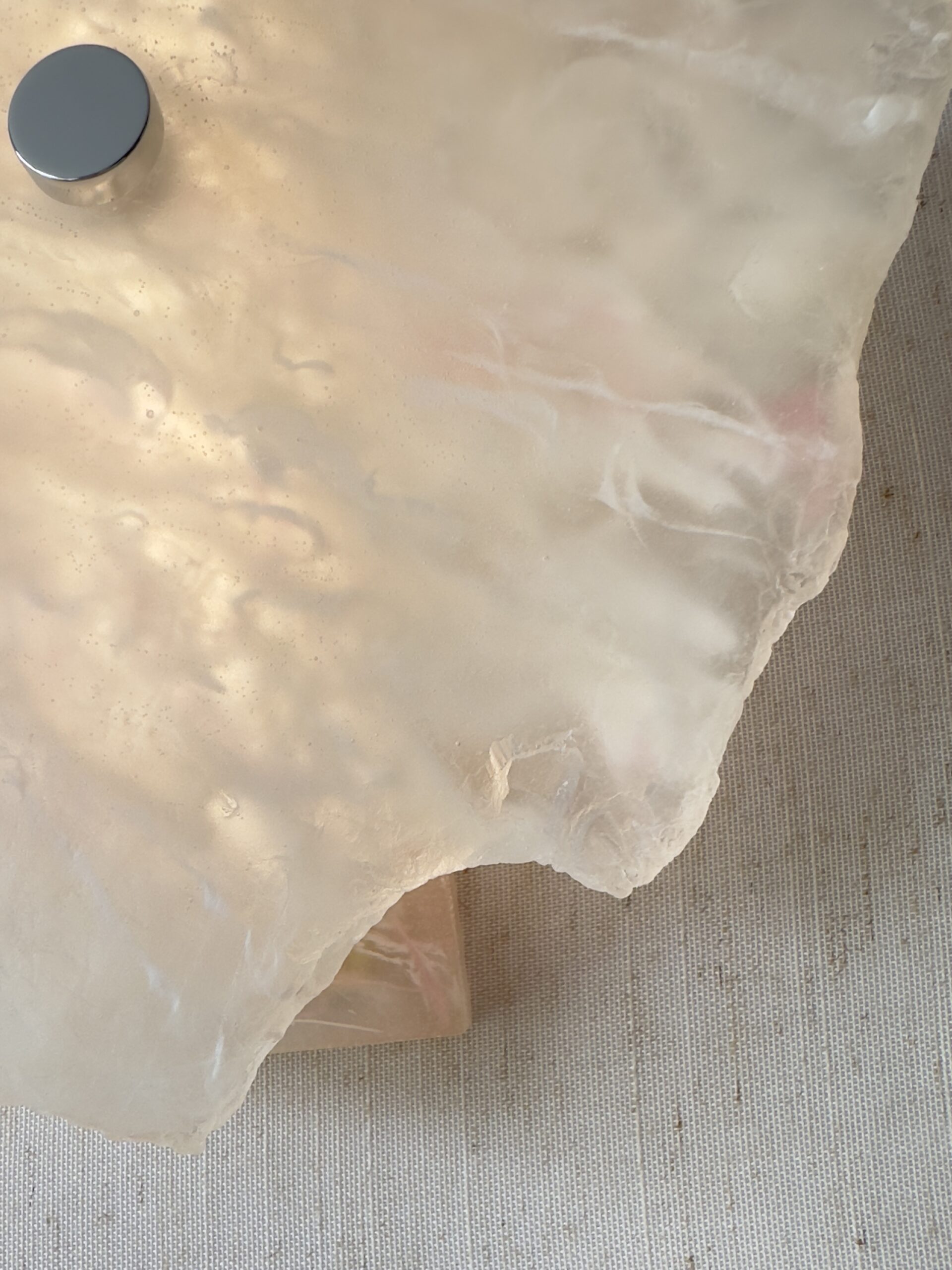 Wireless resin wall sconce with white quartz-inspired finish