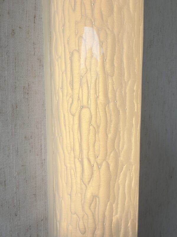 Large vertical wireless resin wall light with sculptural form