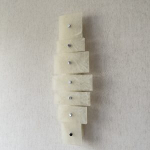 Wireless resin wall sconce with white quartz-inspired finish