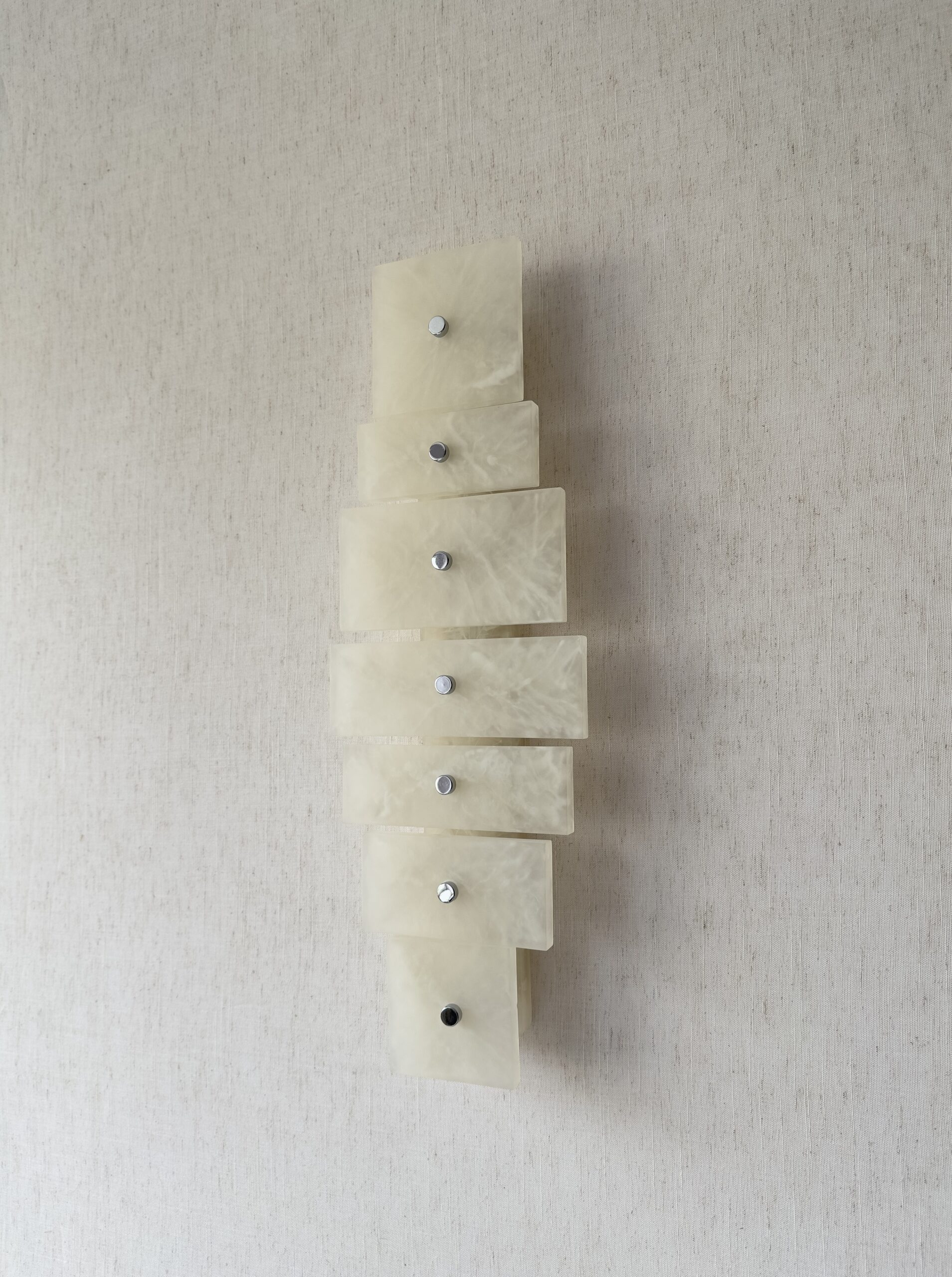 Wireless resin wall sconce with white quartz-inspired finish