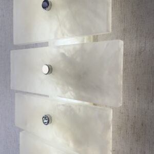 Wireless resin wall sconce with white quartz-inspired finish