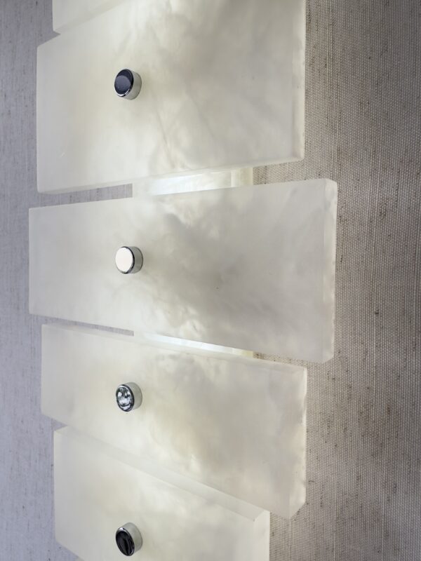 Wireless resin wall sconce with white quartz-inspired finish