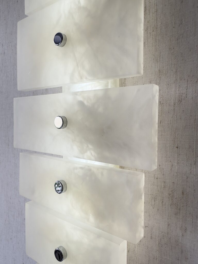 Wireless resin wall sconce with white quartz-inspired finish