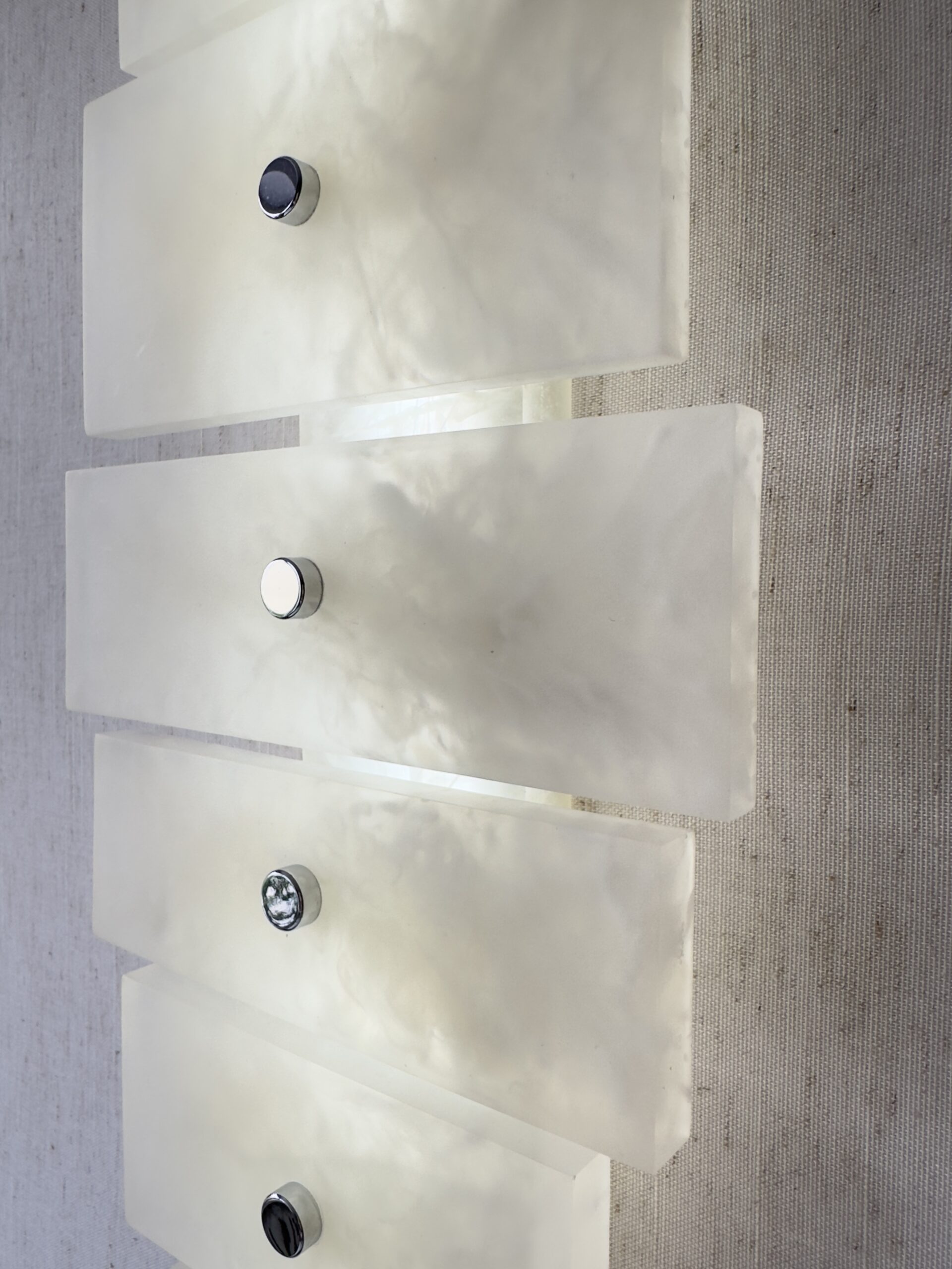 Wireless resin wall sconce with white quartz-inspired finish