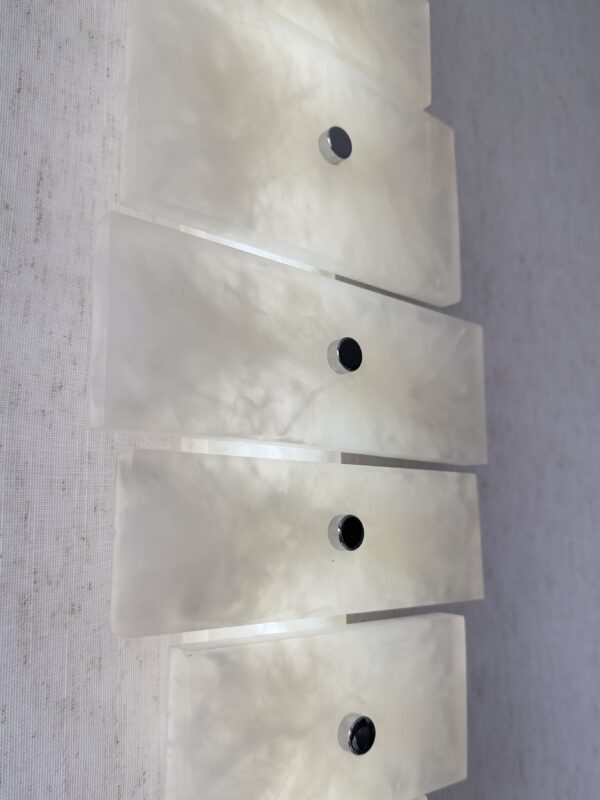 Wireless resin wall sconce with white quartz-inspired finish