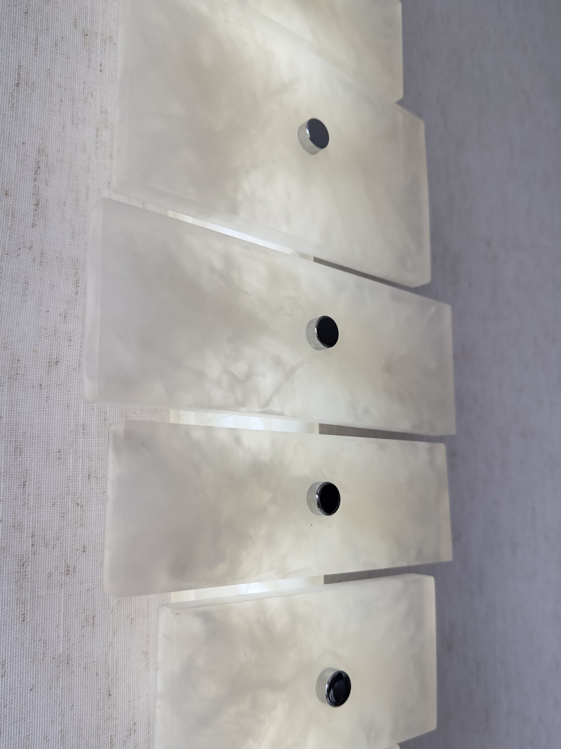 Wireless resin wall sconce with white quartz-inspired finish