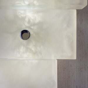Wireless resin wall sconce with white quartz-inspired finish