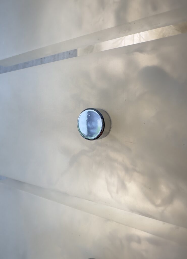 Wireless resin wall sconce with white quartz-inspired finish