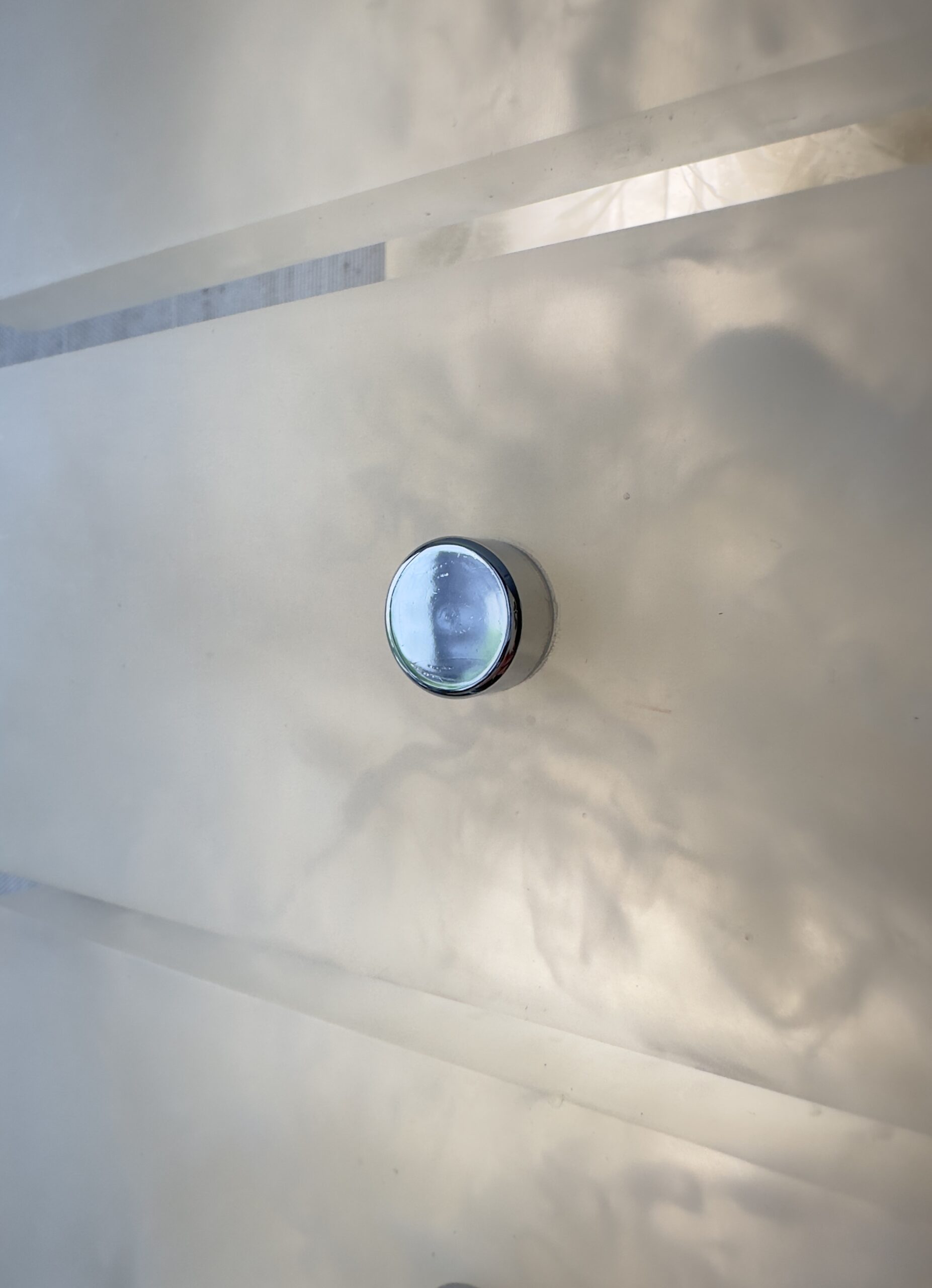 Wireless resin wall sconce with white quartz-inspired finish