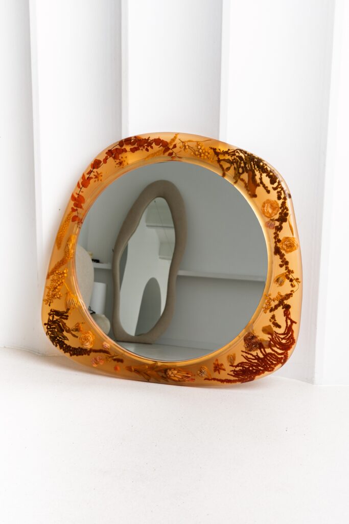 Amber-toned resin mirror with embedded dried flowers